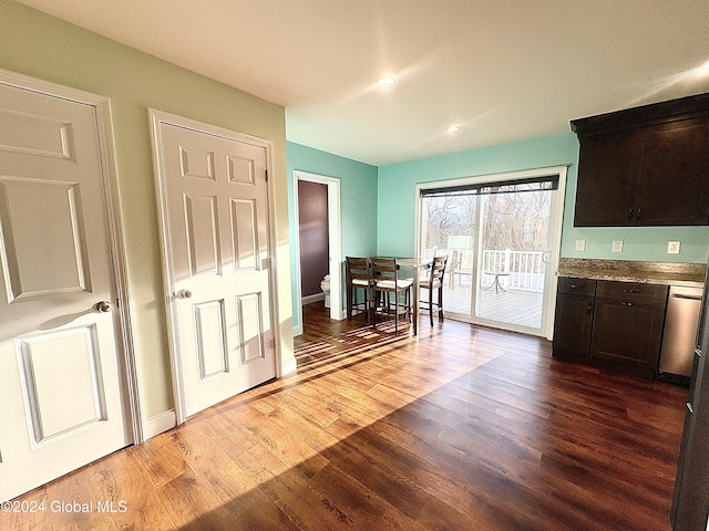 kitchen with dishwasher, dark brown cabinets, and hardwood / wood-style flooring