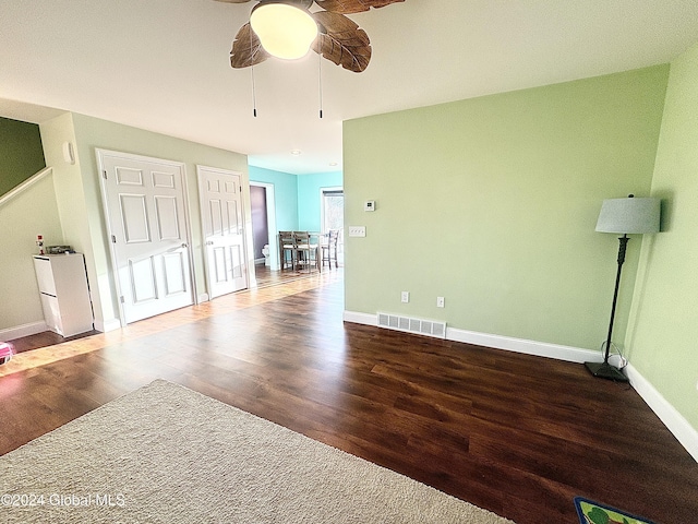 spare room with ceiling fan and dark wood-type flooring