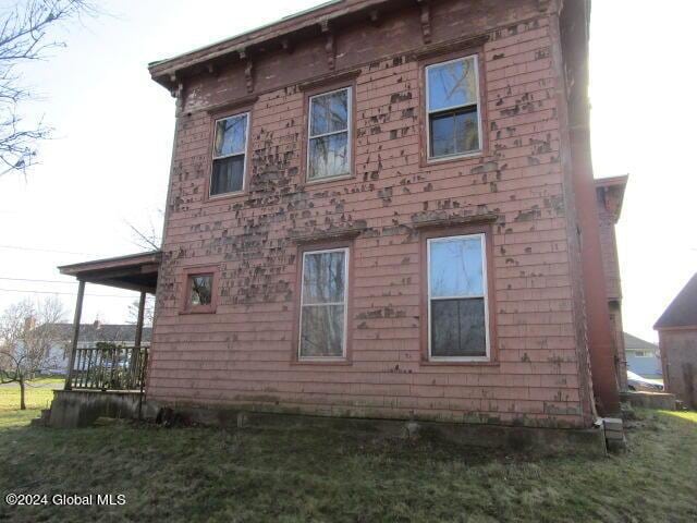 view of side of property with a yard