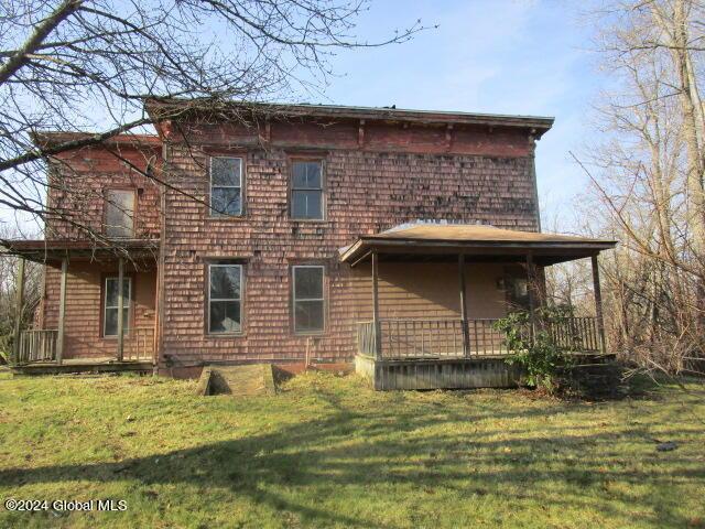 back of property featuring a lawn