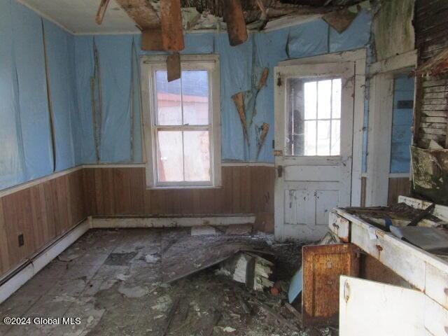 miscellaneous room with wooden walls