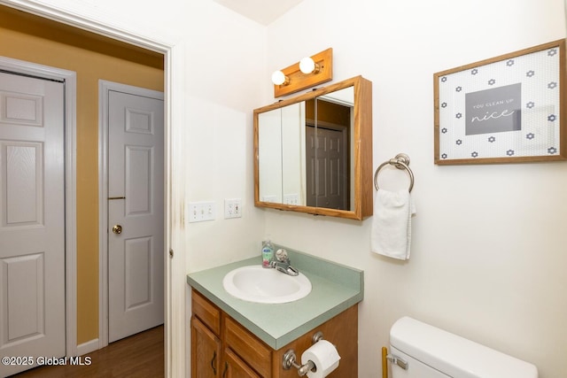 bathroom featuring vanity and toilet