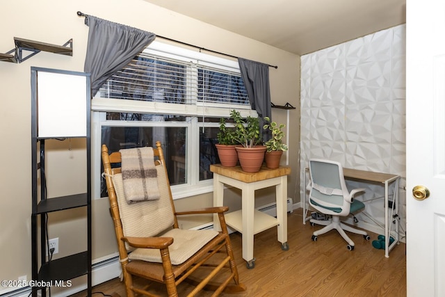 home office with hardwood / wood-style floors and a baseboard heating unit