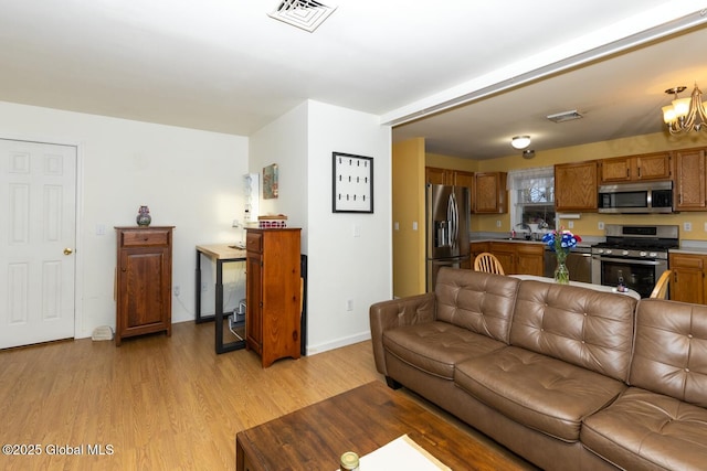 living room with sink and light wood-type flooring