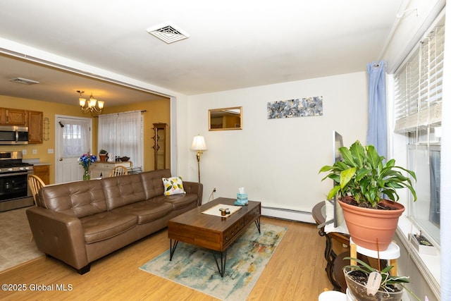 living room featuring a notable chandelier, light wood-type flooring, and a baseboard radiator