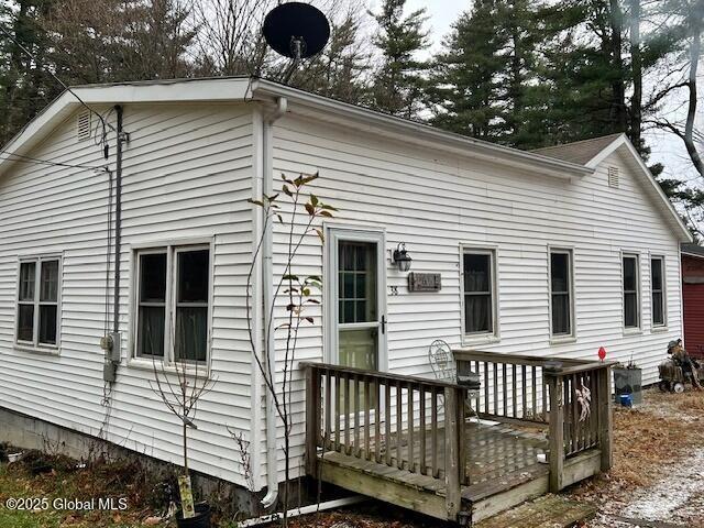 rear view of house with a wooden deck