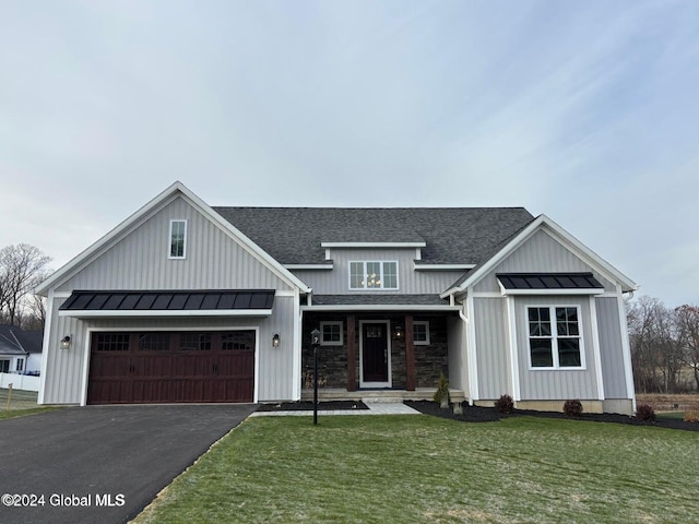 view of front of home with a garage and a front lawn