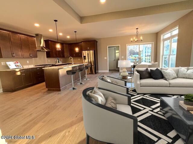 living room featuring light wood-type flooring and a chandelier