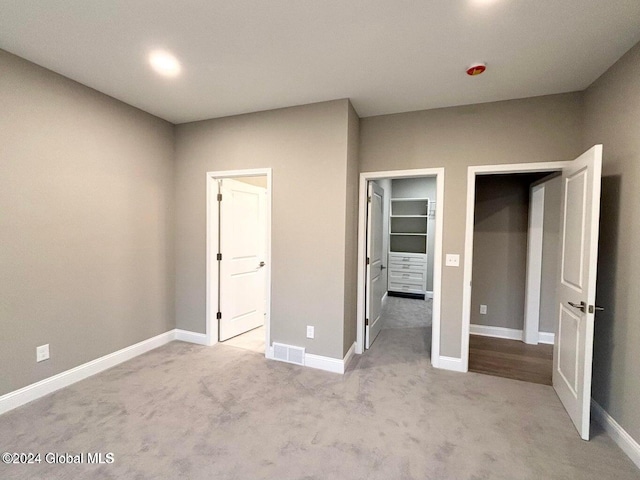 unfurnished bedroom featuring light carpet