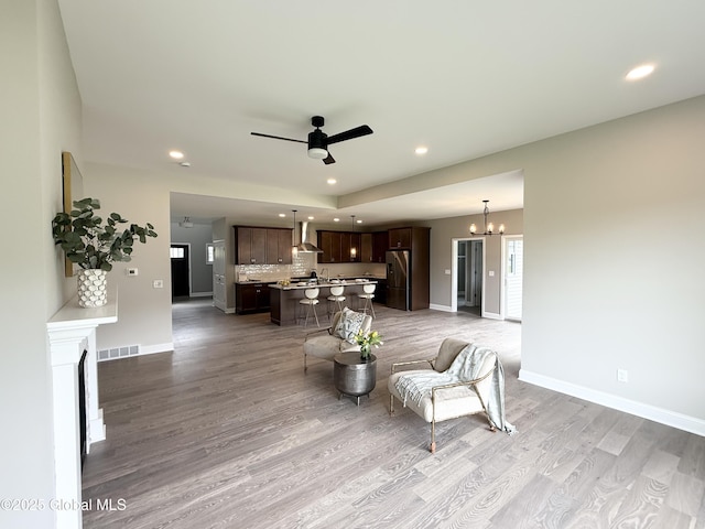 13 Bernie Loop, North Greenbush, NY 12180 - living room featuring wood finished floors, baseboards, recessed lighting, a ceiling fan, and a chandelier