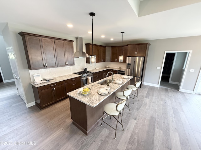 13 Bernie Loop, North Greenbush, NY 12180 - kitchen with wall chimney exhaust hood, stainless steel appliances, dark brown cabinetry, a kitchen breakfast bar, and recessed lighting