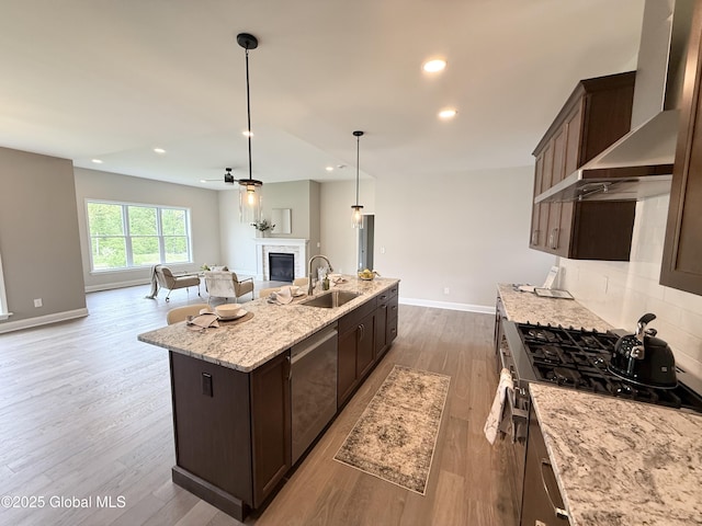 13 Bernie Loop, North Greenbush, NY 12180 - kitchen with range, a sink, open floor plan, a glass covered fireplace, and dark brown cabinets