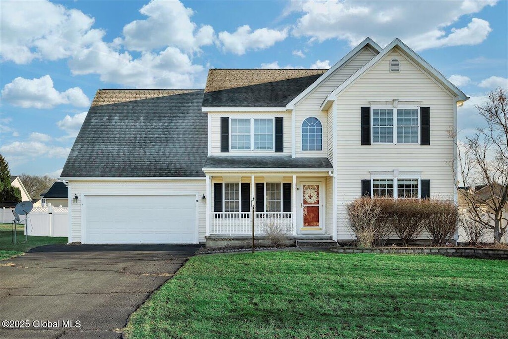 view of front facade with a porch, a garage, and a front lawn