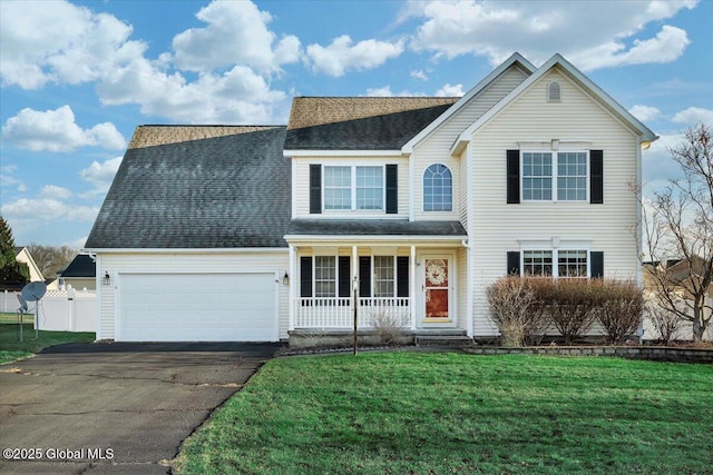 view of front facade with a porch, a garage, and a front lawn