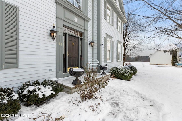 view of snow covered property entrance