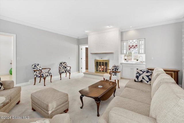 carpeted living room with a fireplace, ornamental molding, and sink