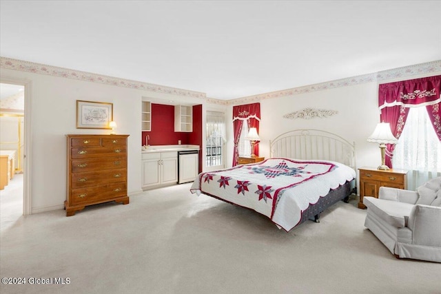 bedroom with light colored carpet and connected bathroom