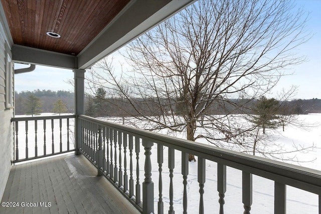 view of snow covered back of property