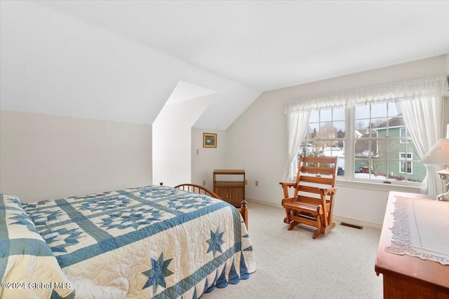 carpeted bedroom featuring lofted ceiling