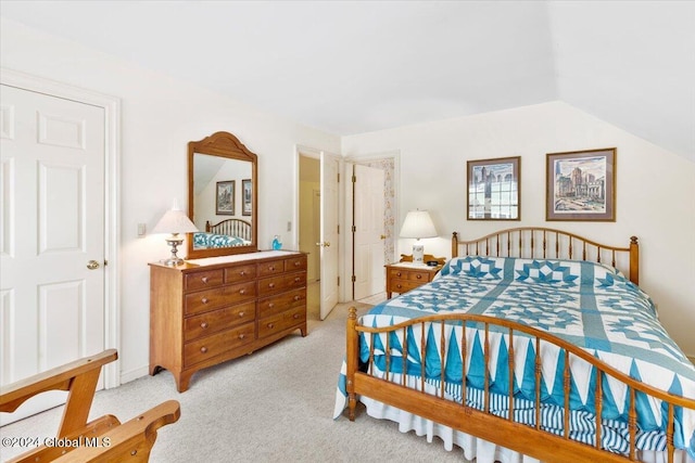 bedroom with light carpet and vaulted ceiling