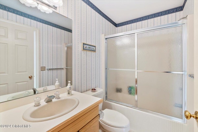 full bathroom with vanity, toilet, and bath / shower combo with glass door