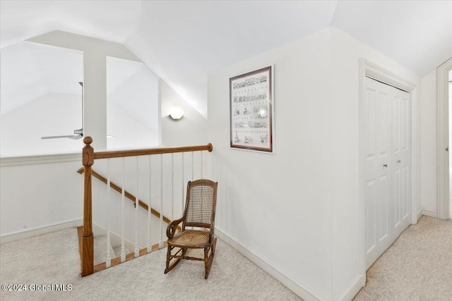 living area featuring light colored carpet and lofted ceiling