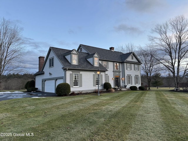 view of front of home with a front yard and a garage