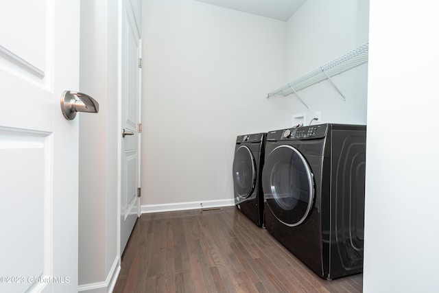 clothes washing area featuring hardwood / wood-style floors and washing machine and dryer