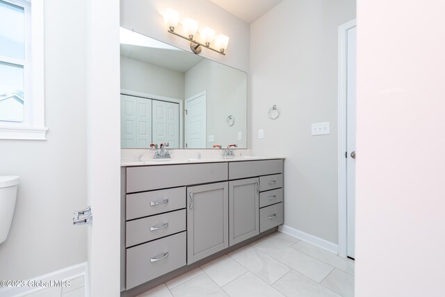 bathroom featuring toilet, vanity, and tile patterned floors