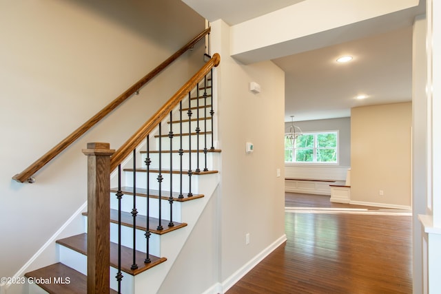 staircase with hardwood / wood-style flooring