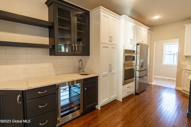 kitchen featuring white cabinetry, sink, wine cooler, decorative backsplash, and fridge with ice dispenser