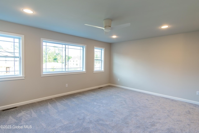 empty room featuring ceiling fan and carpet flooring