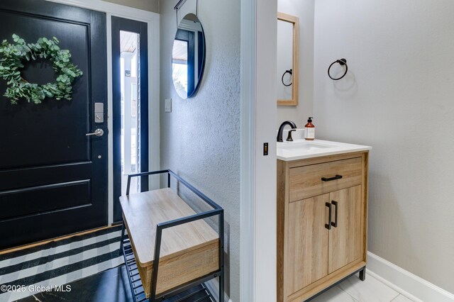 tiled foyer with sink