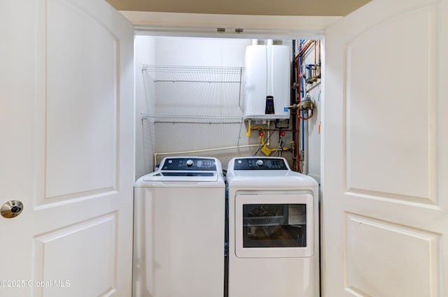 laundry area with tankless water heater and independent washer and dryer