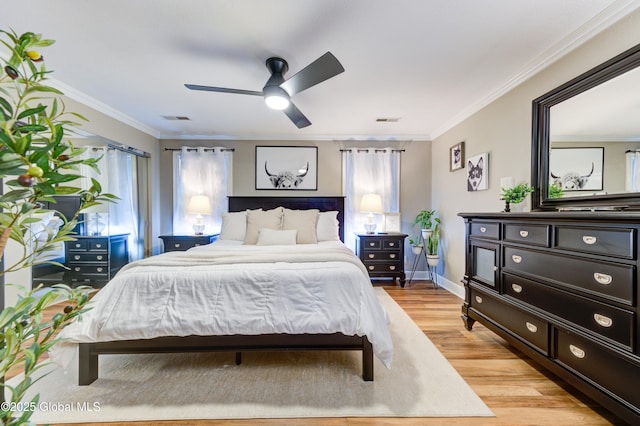 bedroom featuring ornamental molding, multiple windows, ceiling fan, and light wood-type flooring