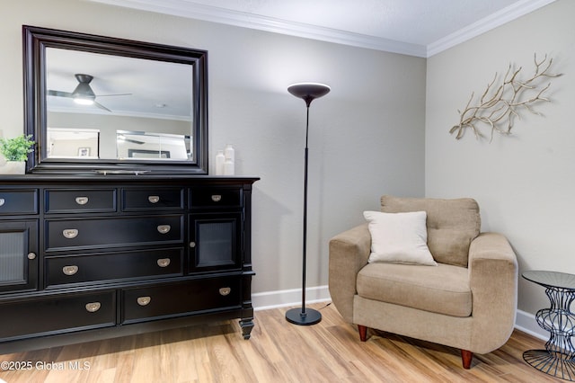 sitting room with wood-type flooring, ceiling fan, and crown molding