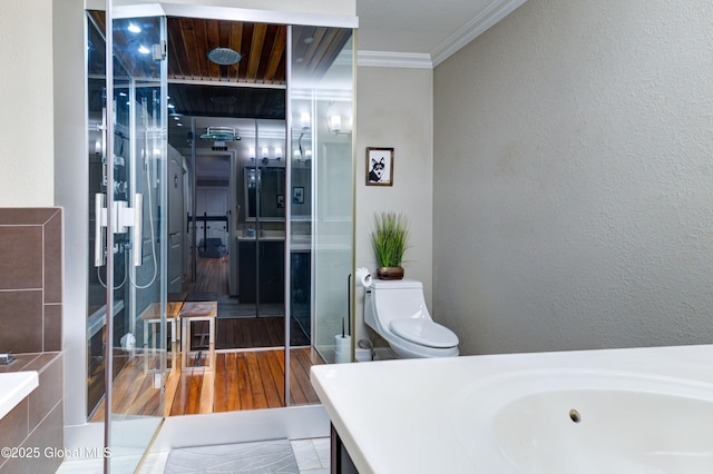 bathroom with toilet, ornamental molding, a bathtub, and vanity