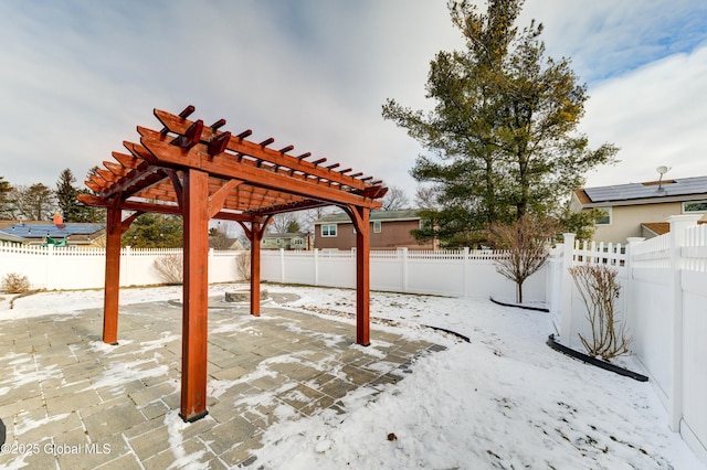 snow covered patio featuring a pergola