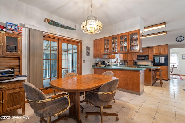 dining room with french doors, sink, and a chandelier