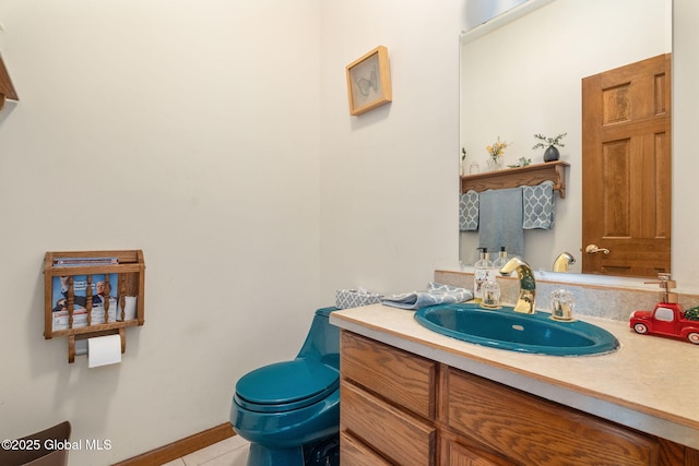 bathroom with tile patterned flooring, vanity, and toilet