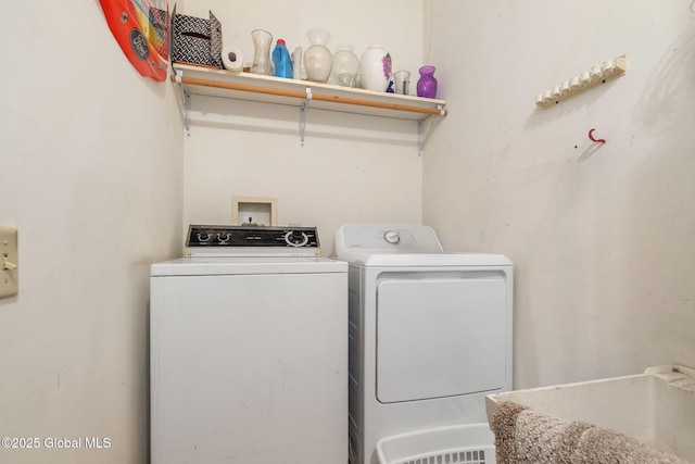 clothes washing area with washing machine and clothes dryer