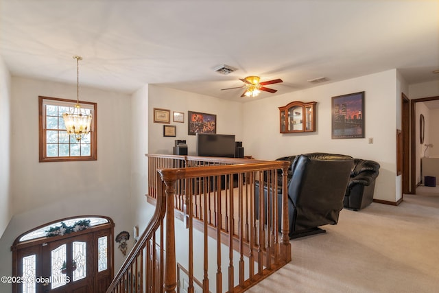 interior space featuring ceiling fan with notable chandelier