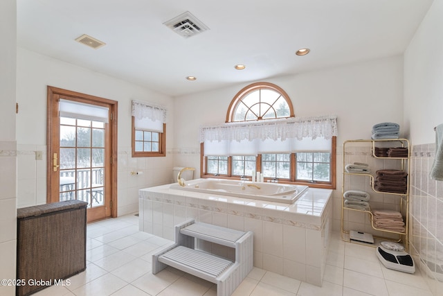 bathroom featuring tile patterned floors and tile walls