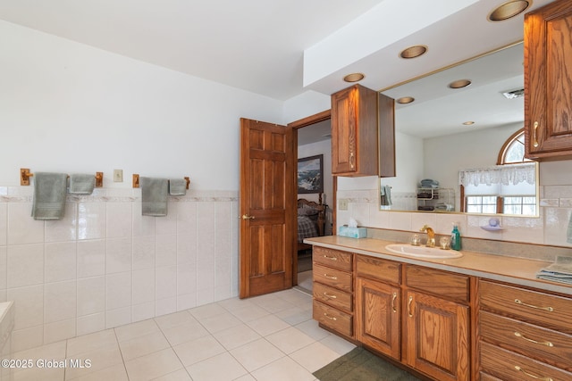 bathroom with vanity, tile patterned floors, and tile walls