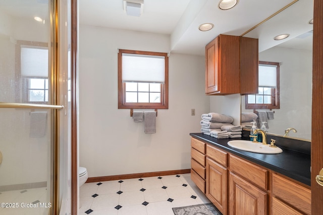 bathroom with vanity, toilet, and a wealth of natural light