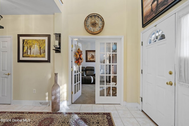 foyer with french doors and light tile patterned floors