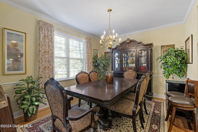 dining area featuring ornamental molding, a chandelier, and wood-type flooring