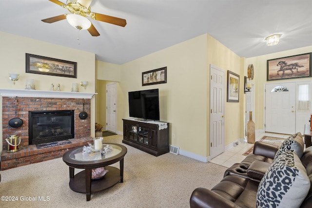 carpeted living room featuring ceiling fan and a fireplace