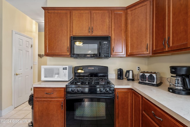 kitchen featuring light tile patterned floors and black appliances