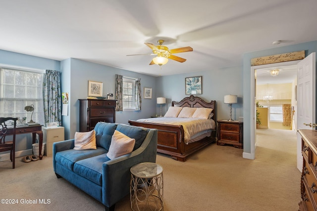 bedroom with ceiling fan and light colored carpet